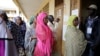 FILE - Women wait to cast their votes during elections, in Briqueterie, Cameroon, Oct. 7, 2018. On Tuesday, coinciding with Women's Day, women in Cameroon rallied demanding broader political power in the country. 