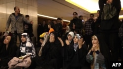 FILE - Iranian fans react after watching the Iran National team lose the Qatar 2022 World Cup Group B football match between the United States and Iran, being shown at Milad Tower in the capital Tehran, Nov. 29, 2022.