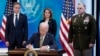 President Joe Biden signs a bill for more assistance to Ukraine, on the White House campus in Washington, March 16, 2022, as Secretary of State Antony Blinken, Deputy Secretary of Defense Kathleen Hicks and Chairman of the Joint Chief of Staff General Mark Milley look on.