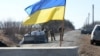 Servicemen of Ukrainian military forces guard a checkpoint, where they hold a position near Kharkiv, March 23, 2022.