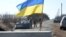 Servicemen of Ukrainian military forces guard a checkpoint, where they hold a position near Kharkiv, March 23, 2022.