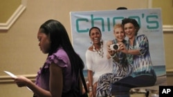 10月3日在美国佐治亚州亚特兰大市的一个招聘会上，一位求职者在看有关资料