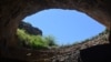 Birds circle the entrance of a cave at Carlsbad Caverns National Park in New Mexico. 