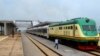 FILE - A man walks past a train of the newly completed Abuja-Kaduna railway line in Abuja, July 21, 2016. 