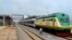 FILE - A man walks past a train of the newly completed Abuja-Kaduna railway line in Abuja, July 21, 2016. 