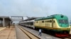FILE - A man walks past a train of the newly completed Abuja-Kaduna railway line in Abuja, July 21, 2016.