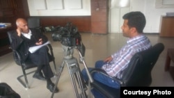 FILE - Almigdad Mojalli conducts an interview, January 2015. Mojalli was one of six journalists killed in Yemen in 2016.