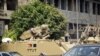 Egyptian army armoured personnel carriers (APC) are stationed outside the Aguza Military Hospital in Cairo, August 19, 2013.