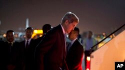 FILE - U.S. Secretary of State John Kerry steps aboard his aircraft after meeting with members of Egypt's government in Cairo, Sunday, Nov. 3, 2013.