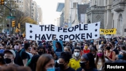 FILE - People gather as they celebrate media announcing that Democratic U.S. presidential nominee Joe Biden has won the 2020 U.S. presidential election, in Philadelphia, Pennsylvania, November 7, 2020.