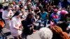 People pray outside the scene of a shooting at a supermarket in Buffalo, New York, May 15, 2022. 