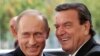 File--- Then-German Chancellor Gerhard Schroeder, right, welcoming Russia's President Vladimir Putin in Berlin, Germany, Sept. 8, 2005. 