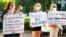 Women hold signs in support of abortion rights as they listen to speeches during a protest in support of legalized abortion at the Mississippi Capitol in Jackson, Miss., May 6, 2022. 