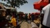 FILE - People trade along a railway line passing through a market in Kaduna, Nigeria, April 30, 2021.