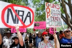 People protest against gun laws outside the National Rifle Association (NRA) annual convention in Houston, Texas, U.S. May 27, 2022. REUTERS/Daniel Kramer