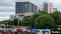 Emergency personnel work at the scene of a shooting at a medical clinic in Tulsa, Okla., June 1, 2022. 