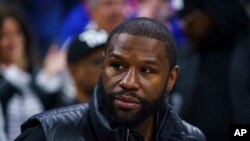 FILE - Boxer Floyd Joy Mayweather Jr. looks on during Game 1 of an NBA basketball first-round playoff series between the Toronto Raptors and the Philadelphia 76ers, Apr. 16, 2022, in Philadelphia.