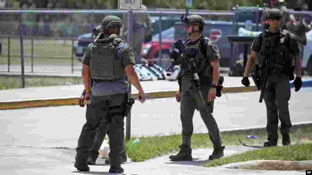 Law enforcement personnel stand outside Robb Elementary School following the shooting, May 24, 2022, in Uvalde, Texas.