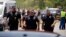 Police officers walk near Robb Elementary School following a mass shooting in Uvalde, Texas, May 24, 2022.