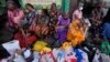 Women wait near an empty fuel station hoping to buy kerosene for cooking, in Colombo, Sri Lanka, May 26, 2022.