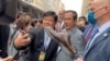 A protester threw a shoe aimed at Cambodia's Prime Minister Hun Sen, during his meet and greet with his supporters in Washington DC, Wednesday, May 11, 2022. 