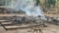 This photo from humanitarian group Free Burma Rangers taken May 3, 2022, and released May 4 shows a dog running past the burning remains of a building after airstrikes and mortar attacks by the Myanmar military, according to the Free Burma Rangers.