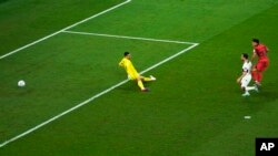 South Korea's Hwang Hee-chan, right, scores his side's second goal during the World Cup group H soccer match between South Korea and Portugal, at the Education City Stadium in Al Rayyan, Qatar, Dec. 2, 2022. 