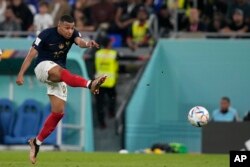 FILE - France's Kylian Mbappe shoots the ball during the World Cup group D soccer match between France and Denmark, at the Stadium 974 in Doha, Qatar, Saturday.