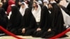 FILE - Iraqi Shiite women take part in the Eid al-Fitr prayer in Baghdad, Iraq, July 29, 2014. Islamic State is imposing a strict dress code on women in Iraq and Syria during Ramadan.