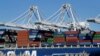 FILE - In this Oct. 26, 2016, photo, a container ship waits to be unloaded at the Port of Oakland, as seen from Alameda, Calif. 