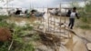 A Cambodian man walks on a bridge from his fishing wooden boat at Mekong river bank near Phnom Penh, Cambodia, July 27, 2011.