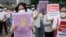 Activists hold posters reading "stop sexual violence" and "free Indonesia from sexual violence", during a rally commemorating the International Women's Day in Jakarta, Indonesia, Tuesday, March 8, 2022. 
