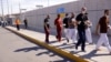 FILE - Cuban migrants who were expelled from the U.S. and sent back to Mexico under Title 42 walk near the at the Lerdo Stanton International border bridge, in Ciudad Juarez, Mexico, May 3, 2022.