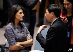 美国常驻联合国代表妮基·黑利与中国常驻联合国副代表吴海涛在联合国总部交谈。（2017年12月22日）