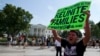 FILE - Carlos Guzman of Albany, Georgia, holds a sign during an immigration reform rally in front of the White House, Washington, July 24, 2013.