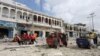 Rescuers carry an unidentified injured man from the scene of an explosion in front of Dayah hotel in Somalia's capital Mogadishu, Jan. 25, 2017.