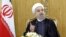 FILE - Iranian President Hassan Rouhani speaks in Tehran. Rouhani ordered his defense minister to expand the ballistic missile program as a response to the threatened U.S. sanctions.