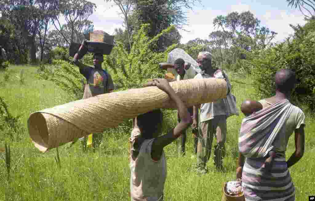 Residents leave with some of their belongings following a second night of attacks in the remote village of Kaisari, near Mpeketoni, about 60 miles (100 kilometers) from the Somali border on the coast of Kenya.
