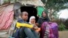 Ubah Mohammed Abdule, 33, right, sits with her son Abdullahi Yusuf Ahmed, 8, left, and daughter Neshad Yusuf Ahmed, 5, center, outside her hut in the Shedder refugee camp in far eastern Ethiopia. 