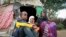 Ubah Mohammed Abdule, 33, right, sits with her son Abdullahi Yusuf Ahmed, 8, left, and daughter Neshad Yusuf Ahmed, 5, center, outside her hut in the Shedder refugee camp in far eastern Ethiopia. 