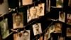 FILE - Family photographs of some of those who died in the Rwandan genocide hang in a display in a memorial center in Kigali, Rwanda, April 5, 2014.