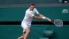FILE - Russia's Daniil Medvedev in action during his third round match against Croatia's Marin Cilic, Wimbledon, July 3, 2021.