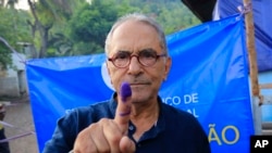 FILE - East Timorese presidential candidate who is also former President Jose Ramos-Horta shows his inked finger after casting his ballot at a polling station during the election in Dili, East Timor on March 19, 2022. 