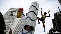 A runner is dressed in a costume depicting the Rio 2016 Olympic torch, decorated with a figure of Jamaica's Usain Bolt and a pill, before the annual "Sao Silvestre Run" (Saint Silvester Road Race), an international race through the streets of Sao Paulo, B