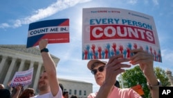 FILE - Immigration activists rally outside the Supreme Court as the justices hear arguments over the Trump administration's plan to ask about citizenship on the 2020 census, in Washington, April 23, 2019.