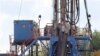 A crew works on a gas-drilling rig at a well site for shale-based natural gas in Zelienople, Pa., June 25, 2012.