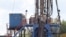 A crew works on a gas-drilling rig at a well site for shale-based natural gas in Zelienople, Pa., June 25, 2012.