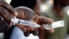 FILE - A Congolese health worker prepares to vaccinate a resident during an emergency campaign of vaccination against yellow fever in Kisenso district, of the Democratic Republic of Congo's capital Kinshasa, July 20, 2016.