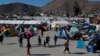 Migrants walk inside a former concert venue serving as a shelter in Tijuana, Mexico, Dec. 3, 2018.