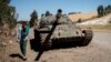 FILE - A young man walks past a destroyed tank near Debre Tabor, Ethiopia, Dec. 6, 2021. Ethiopian and Eritrean forces launched a "massive" joint offensive against the Tigray People's Liberation Front in the northern region of Tigray on Sept. 1, 2022, the